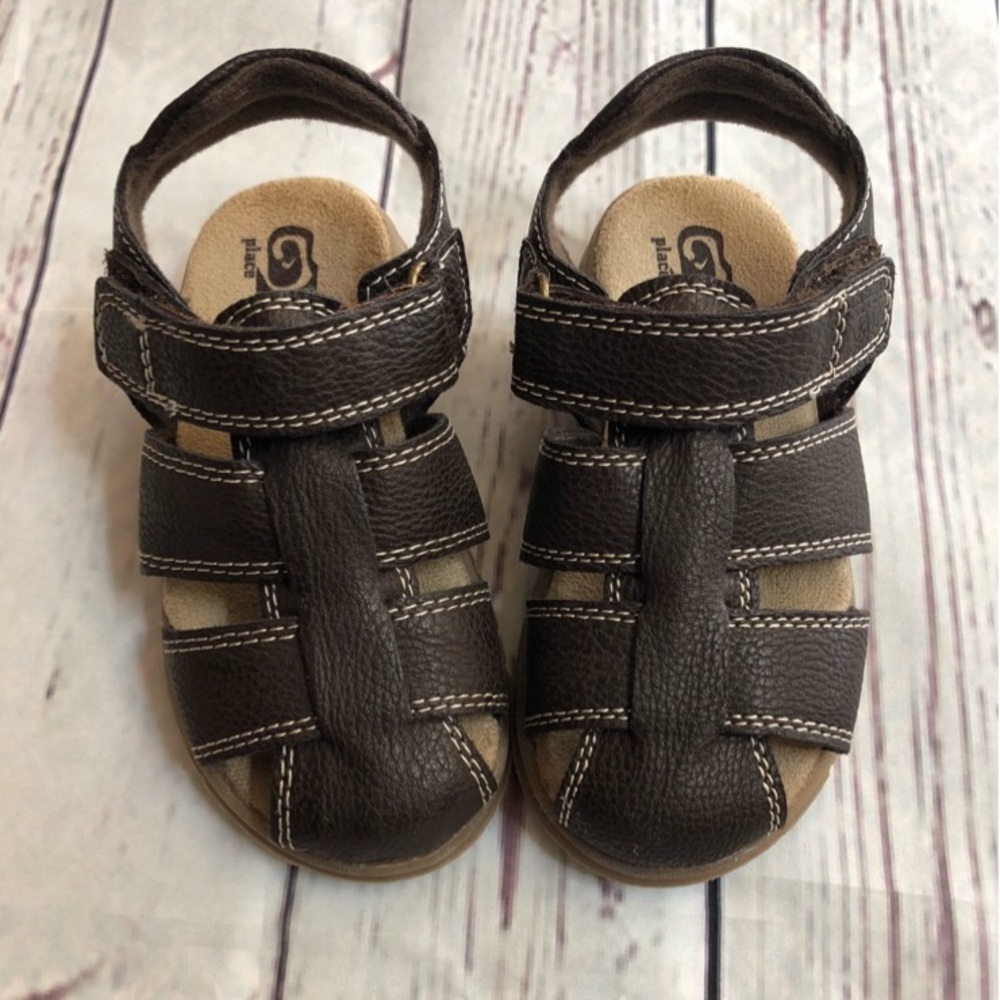 Place boys brown sandals